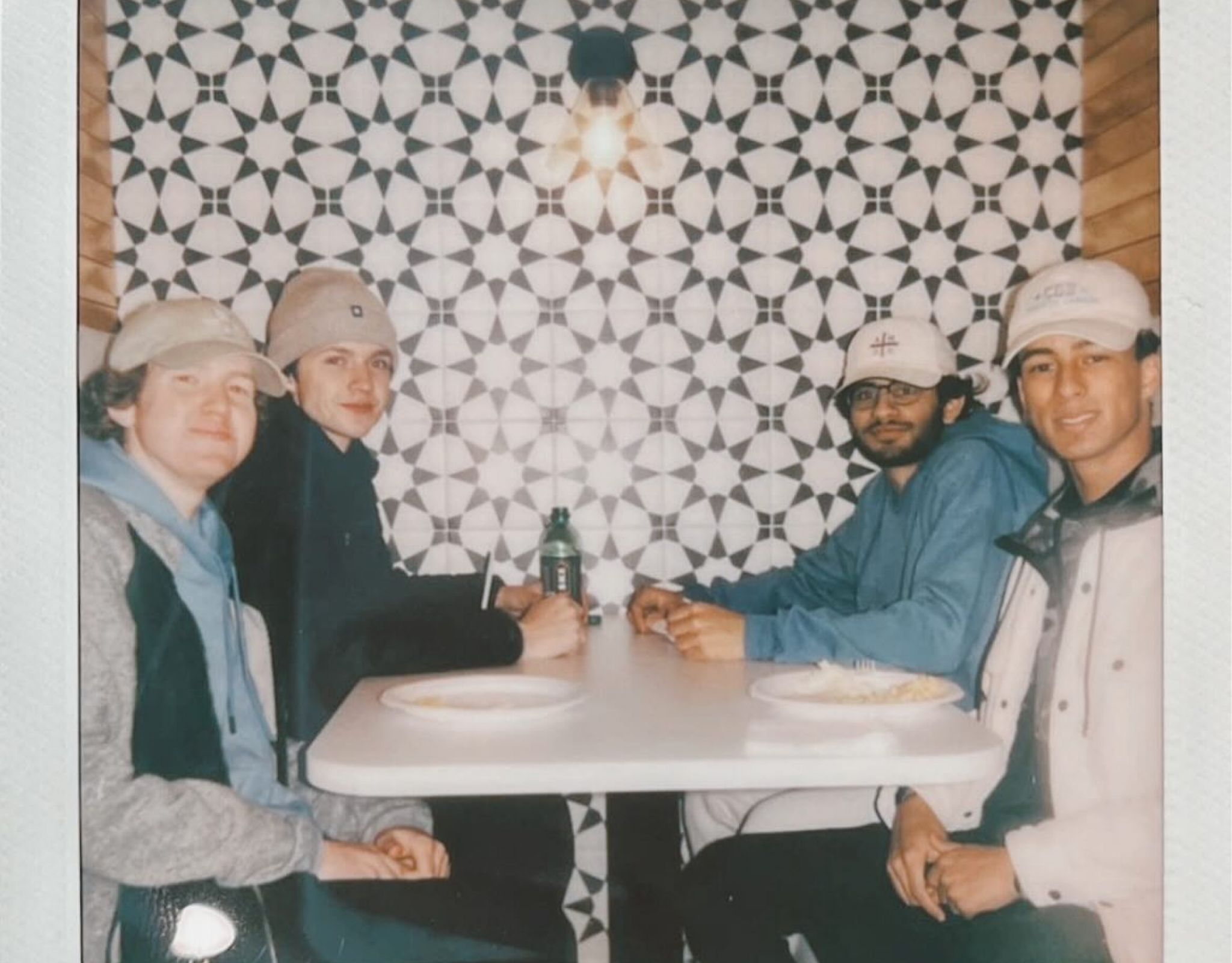 Group of young men eating at table at VERVE St. Louis