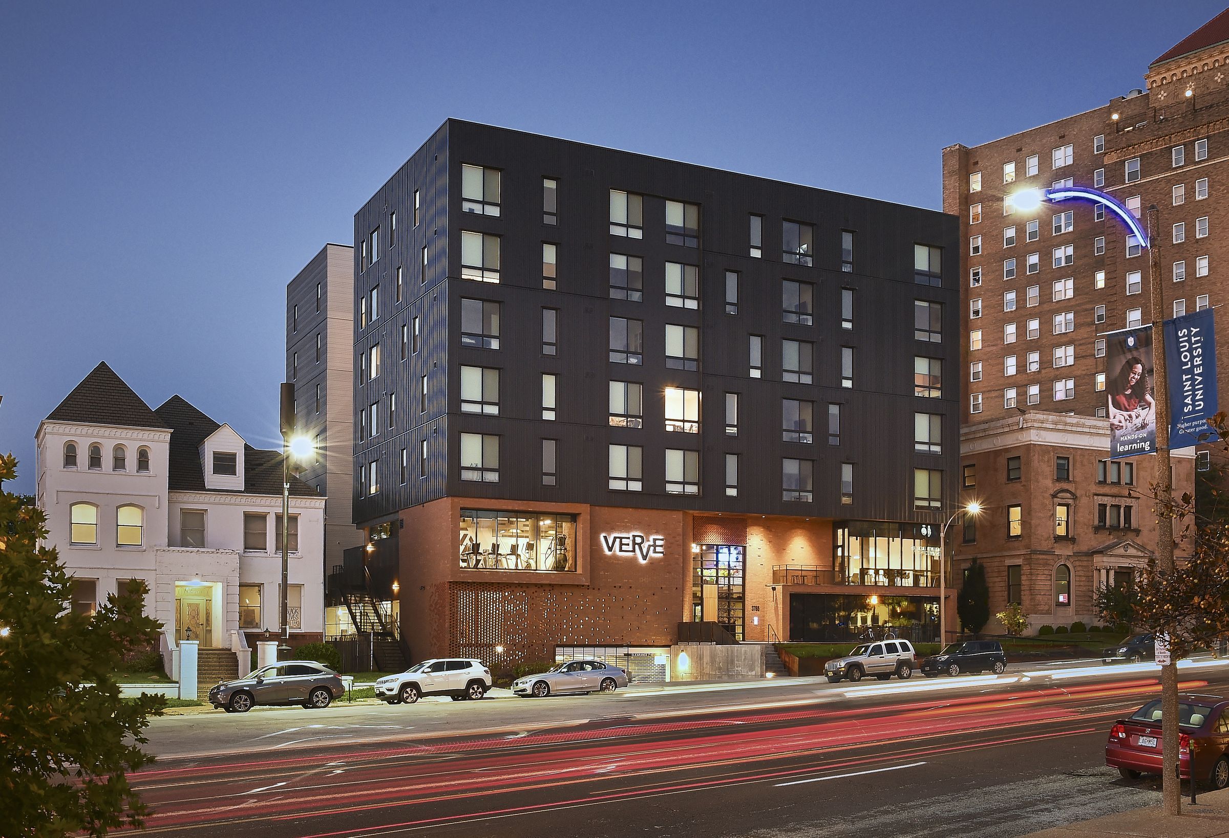 VERVE St. Louis Exterior shot at night from across the street showing large apartment building with modern exterior