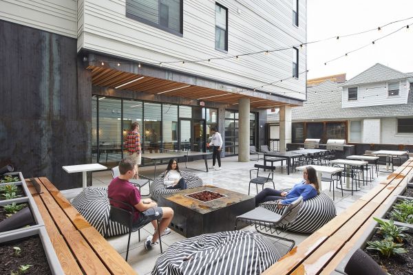 Outdoor Terrace at VERVE St. Louis with students socializing around an outdoor fire pit