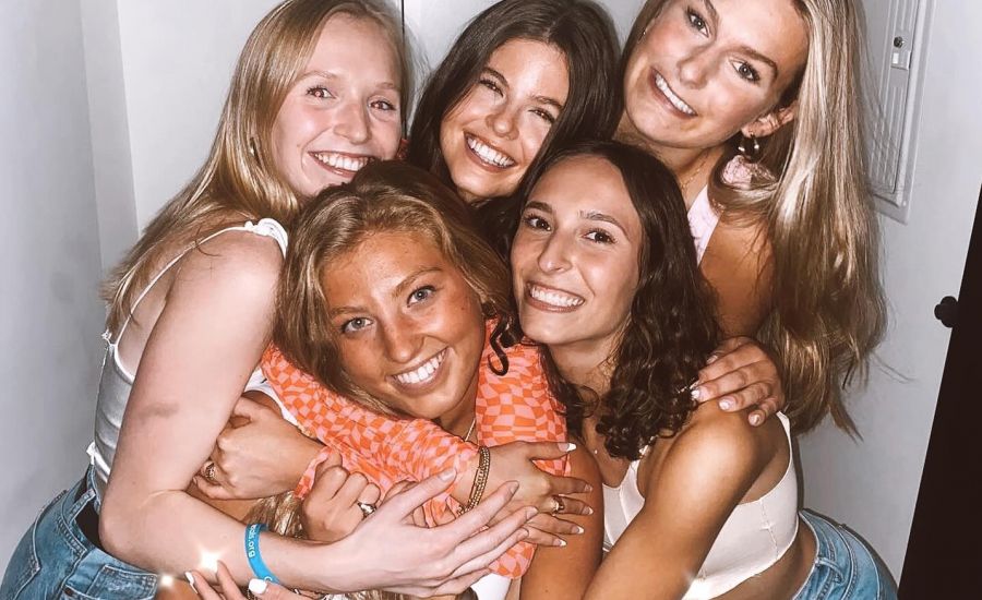 Group of young women hugging at apartment in VERVE St. Louis