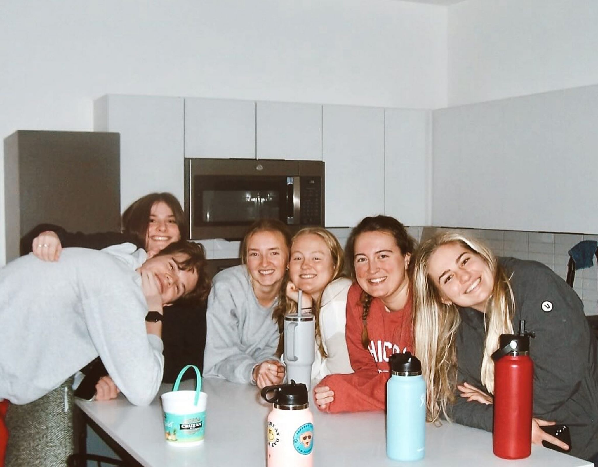VERVE St.Louis friends hanging out in a kitchen smiling