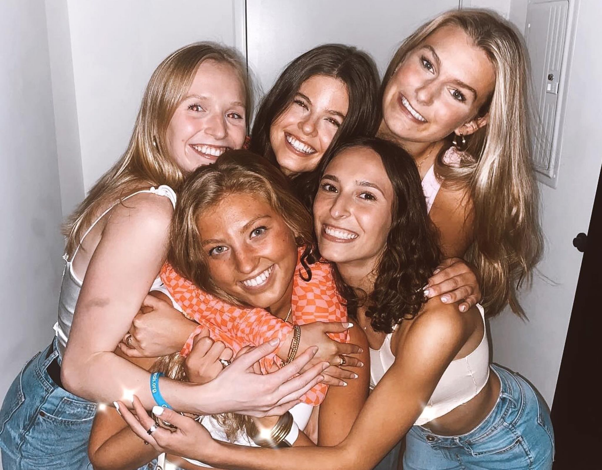 Group of young women hugging at apartment in VERVE St. Louis