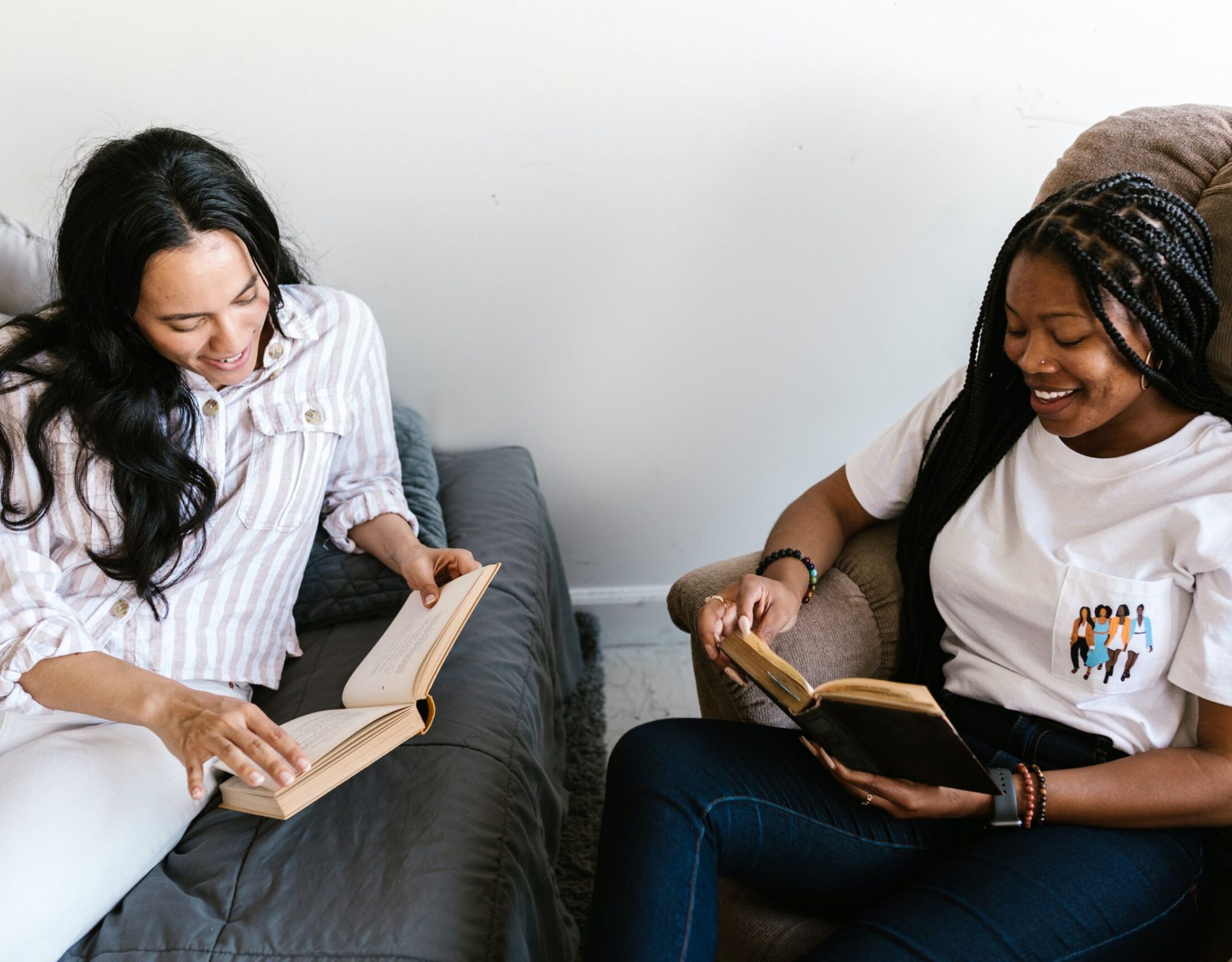 two people sitting and reading books